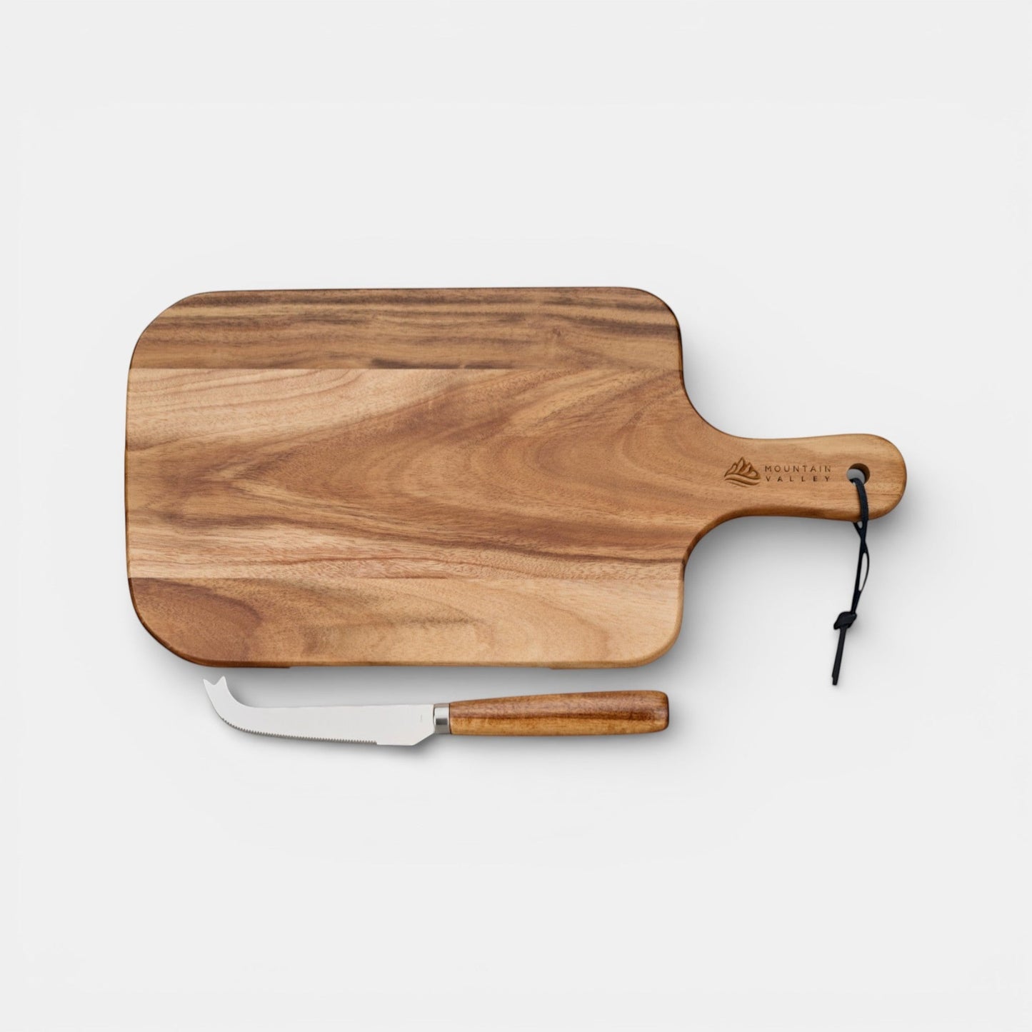 Impression M acacia wood cheese board with stainless steel knife and hanging strap on a white background