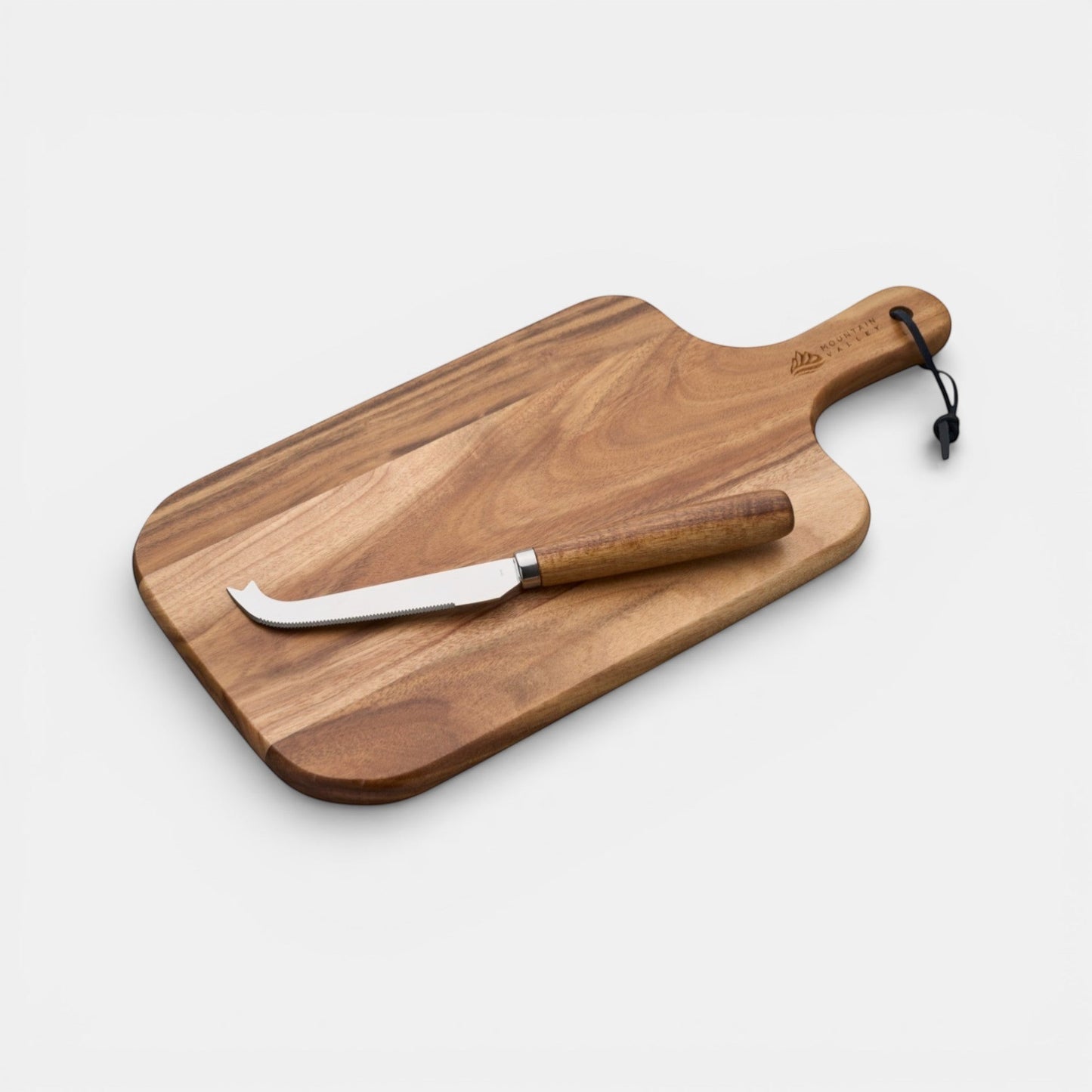 Impression M acacia wood cheese board with stainless steel knife and hanging strap for serving and preparation.